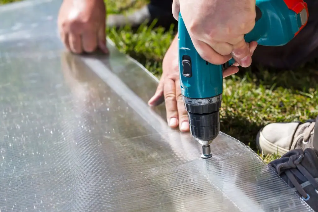 Worker working on polycarbonate plastic installation