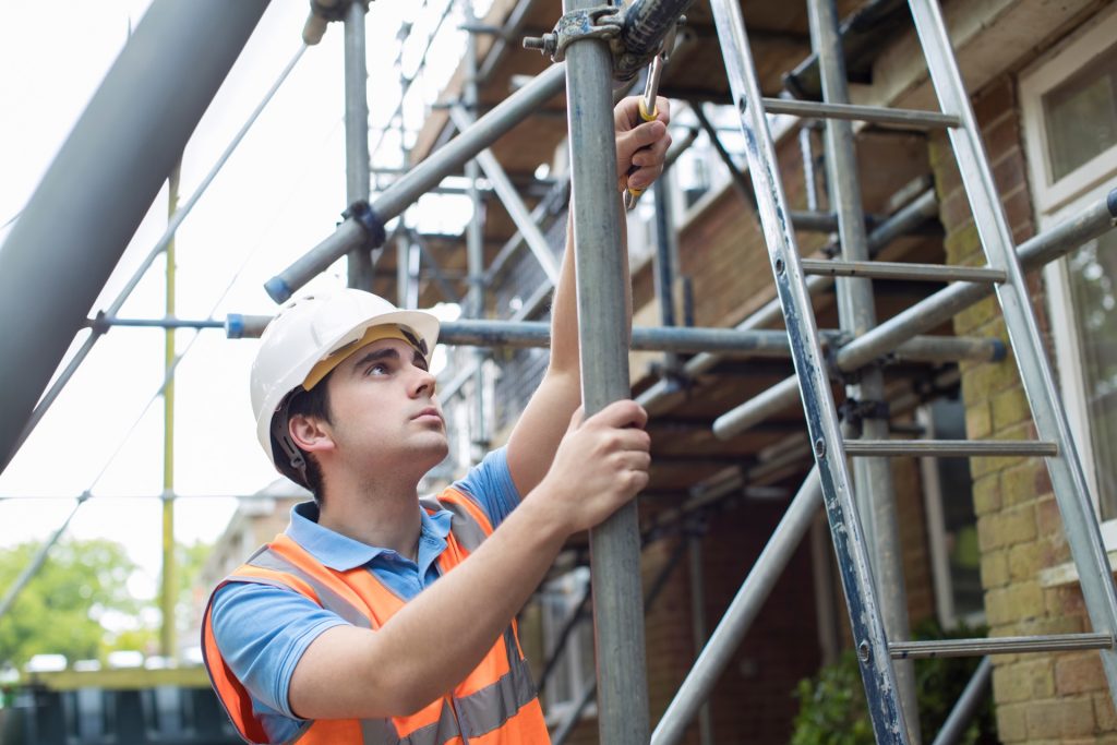 builder putting up aluminum scaffolding